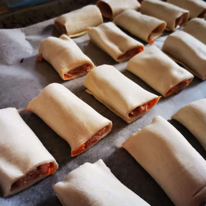 place mini sausage rolls on baking sheet