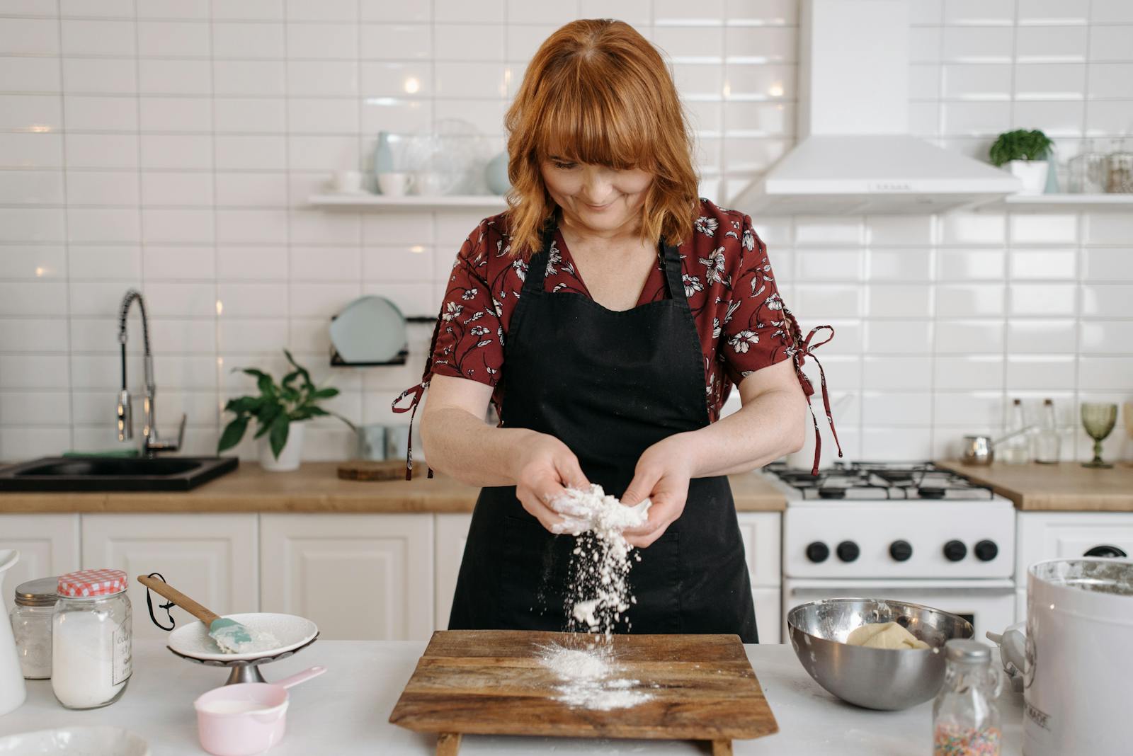 Woman preparing dough for baking in a home kitchen